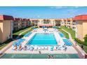 Aerial view of condo complex pool, sundeck, and shuffleboard at 3801 S Atlantic Ave # 321, New Smyrna Beach, FL 32169