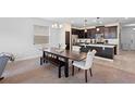 Bright dining room features a dark wood table with bench seating and a view into the kitchen at 11109 Folklore St, Winter Garden, FL 34787