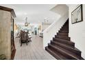 Modern dark wood staircase leading to upper level at 7706 Graben St, Kissimmee, FL 34747