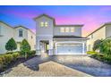 Two-story home with stone accents and a two-car garage at 7706 Graben St, Kissimmee, FL 34747