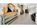 Bright entryway with wood-look tile floors and stylish console table at 7706 Graben St, Kissimmee, FL 34747