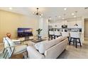 Open living space with kitchen, large TV and comfortable seating at 7143 Oakmoss Loop, Davenport, FL 33837