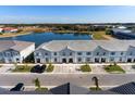Aerial view of townhomes near a lake at 7143 Oakmoss Loop, Davenport, FL 33837