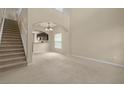 Spacious living room with high ceilings and stairs at 889 Park Grove Ct, Orlando, FL 32828