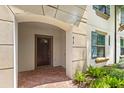 Inviting townhouse entryway with a dark brown door and brick walkway at 2015 Majorca Drive, Kissimmee, FL 34747