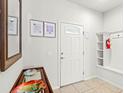 Bright and airy entryway with a bench, mirror and interior door at 2015 Majorca Drive, Kissimmee, FL 34747