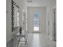 Bright entryway with tile floors and a modern mirror at 4637 Target Blvd, Kissimmee, FL 34746