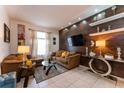 Bright living room with comfy sectional sofa and a modern TV at 5237 Oakbourne Ave, Davenport, FL 33837