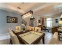 Elegant dining room features a spacious table with modern lighting at 5237 Oakbourne Ave, Davenport, FL 33837