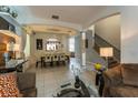 Open concept dining room with a large table and view into the living room at 5237 Oakbourne Ave, Davenport, FL 33837