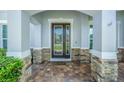 Inviting front entrance with stone accents and a glass-paneled door at 308 Chandler Cir, Oviedo, FL 32765