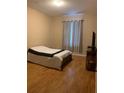 Simple bedroom with a bed, window, and wood flooring at 8710 Saratoga Inlet Dr # 305, Orlando, FL 32829