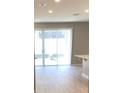 Bright and airy living room with sliding glass doors at 8073 Cherrystone St, Leesburg, FL 34748
