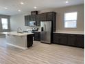 Modern kitchen with stainless steel appliances and an island at 8073 Cherrystone St, Leesburg, FL 34748