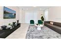 Modern living room with large TV, comfortable seating and stylish decor at 7252 Oakmoss Loop, Davenport, FL 33837