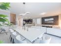 Modern dining room with white table and kitchen access at 9076 Hazard St, Davenport, FL 33896
