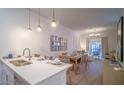 Open concept kitchen with island and stainless steel appliances at 387 Famagusta Dr, Davenport, FL 33896