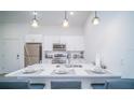 Modern kitchen with white cabinets and island at 387 Famagusta Dr, Davenport, FL 33896