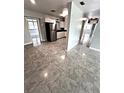 Modern kitchen with stainless steel appliances and tile floors at 520 Avenue L Se, Winter Haven, FL 33880