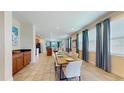 Open dining room with a large table and view into the living area at 601 Lasso Dr, Kissimmee, FL 34747