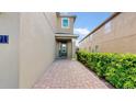 Inviting entryway with a brick walkway and lush landscaping at 601 Lasso Dr, Kissimmee, FL 34747