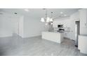 Modern kitchen with white cabinets, granite counters, and island at 2659 Trafalgar Blvd, Kissimmee, FL 34758