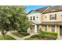 Two-story townhome with attractive landscaping and a welcoming front porch at 5102 Caspian St, Saint Cloud, FL 34771