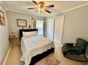 Bright bedroom with a queen-size bed and rocking chair at 5135 Warrior Ln, Kissimmee, FL 34746