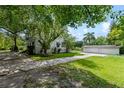 Side view of a house with a detached garage and a stone pathway at 1803 E Kaley Ave, Orlando, FL 32806