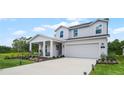Two-story house with a front porch, attached garage, and landscaped lawn at 1105 Pacific Dunes Ct, Daytona Beach, FL 32124