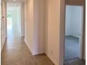 Bright hallway with tile floors and access to other rooms at 6821 Serpent Hawk Lane St, Howey In The Hills, FL 34737
