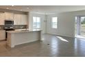 Spacious kitchen featuring a large island, stainless steel appliances, and white cabinets at 6821 Serpent Hawk Lane St, Howey In The Hills, FL 34737