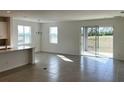 Open concept kitchen with island, stainless steel appliances, and access to backyard at 6821 Serpent Hawk Lane St, Howey In The Hills, FL 34737