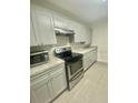 Modern kitchen with stainless steel appliances and granite countertops at 5540 Devonbriar Way # 108, Orlando, FL 32822