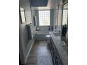 Elegant bathroom with marble vanity, soaking tub, and glass block window at 2603 Coventry Ln, Ocoee, FL 34761