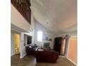 Spacious living room featuring high ceilings, a fireplace, and a loft area at 2603 Coventry Ln, Ocoee, FL 34761