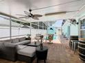 Relaxing screened patio with pool, seating area, and bar at 721 Camel Ct, Kissimmee, FL 34759