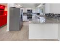 Modern kitchen with granite countertops and stainless steel appliances at 4934 Samoa Cir # 7, Orlando, FL 32808