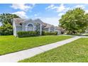 House exterior featuring a well-maintained lawn and landscaping at 12337 Greco Dr, Orlando, FL 32824