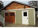 Rustic-style detached garage with double doors and side entry at 925 14Th St, Saint Cloud, FL 34769