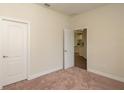 Spacious bedroom with carpet, open door to kitchen area at 34 Dogwood Dr Crse, Ocala, FL 34472