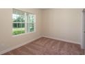 Bright bedroom with carpeted floor and large window at 34 Dogwood Dr Crse, Ocala, FL 34472