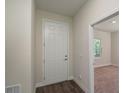 Light and bright entryway with white door and wood-look flooring at 34 Dogwood Dr Crse, Ocala, FL 34472