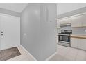 Clean entryway with light gray walls and a view into the kitchen at 2384 Sun Valley Cir, Winter Park, FL 32792