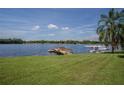 Serene lakefront view with a private dock and seaplane at 16600 Cleveland Ln, Umatilla, FL 32784