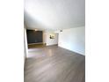 Spacious living room with gray laminate wood flooring at 2557 N Alafaya Trl # 111, Orlando, FL 32826