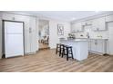 Modern kitchen with white shaker cabinets, quartz countertops, and island at 1500 N Clearview Ave, Deland, FL 32724