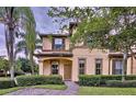 Two-story house with brown roof and landscaping at 744 La Mirage St, Davenport, FL 33897