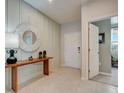 Light and airy entryway with console table and mirror at 12922 Trovita Dr, Grand Island, FL 32735