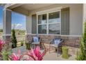 Inviting front porch with seating and landscaping at 12922 Trovita Dr, Grand Island, FL 32735